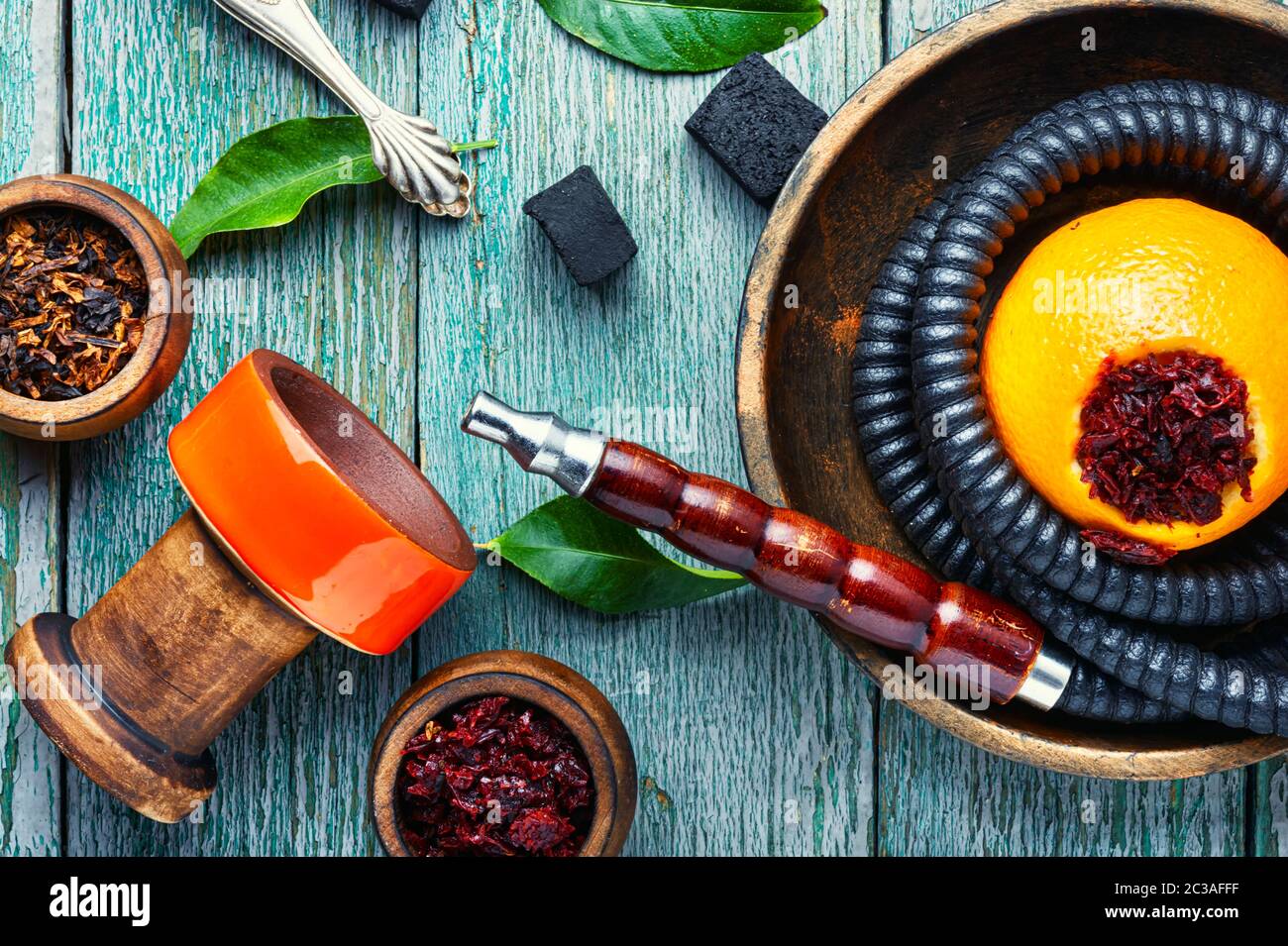Smoking hookah pipe with mouthpiece and citrus flavored shisha tobacco