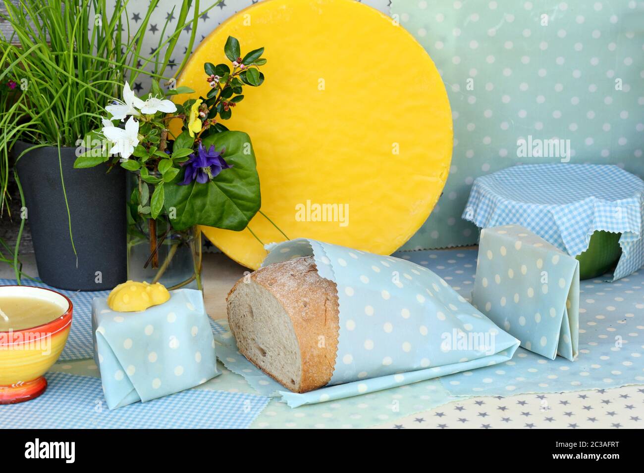 some bread and cheese in wax-clothing on a table Stock Photo