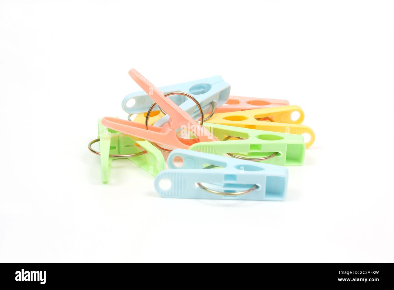 Color clothes-pegs over white Stock Photo