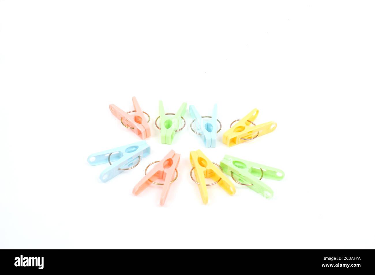 Color clothes-pegs over white Stock Photo