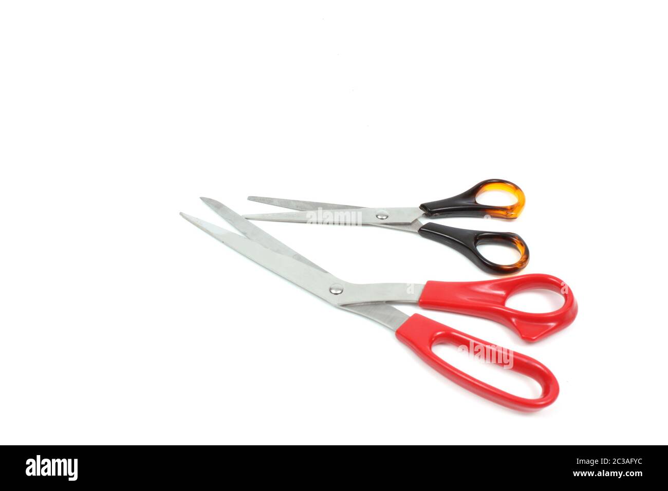 Two scissors with color handles over white Stock Photo - Alamy