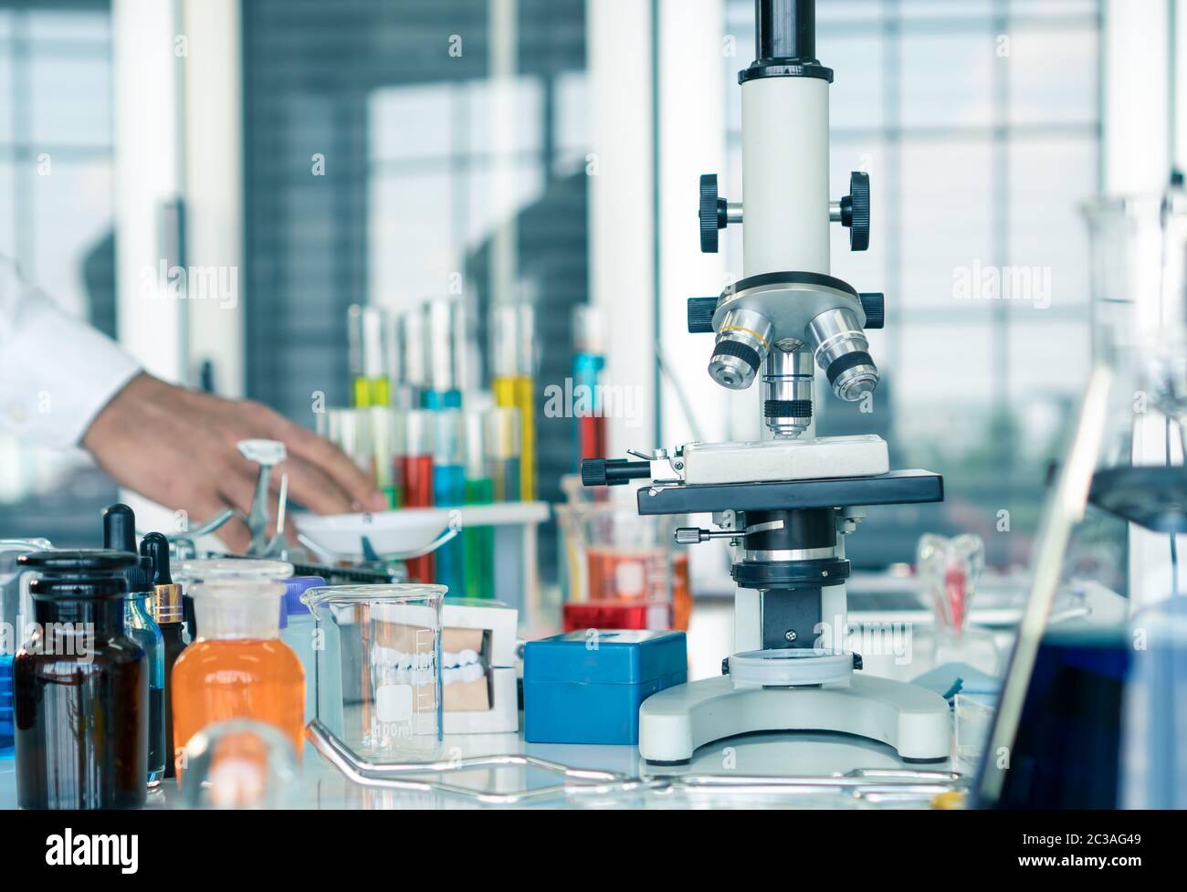 The microscope is located on the table in a scientist's laboratory and ...