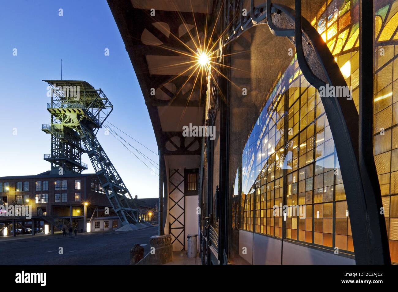 Illuminated machine hall with head frame at twilight, Zeche Zollern, Dortmund, Germany, Europe Stock Photo