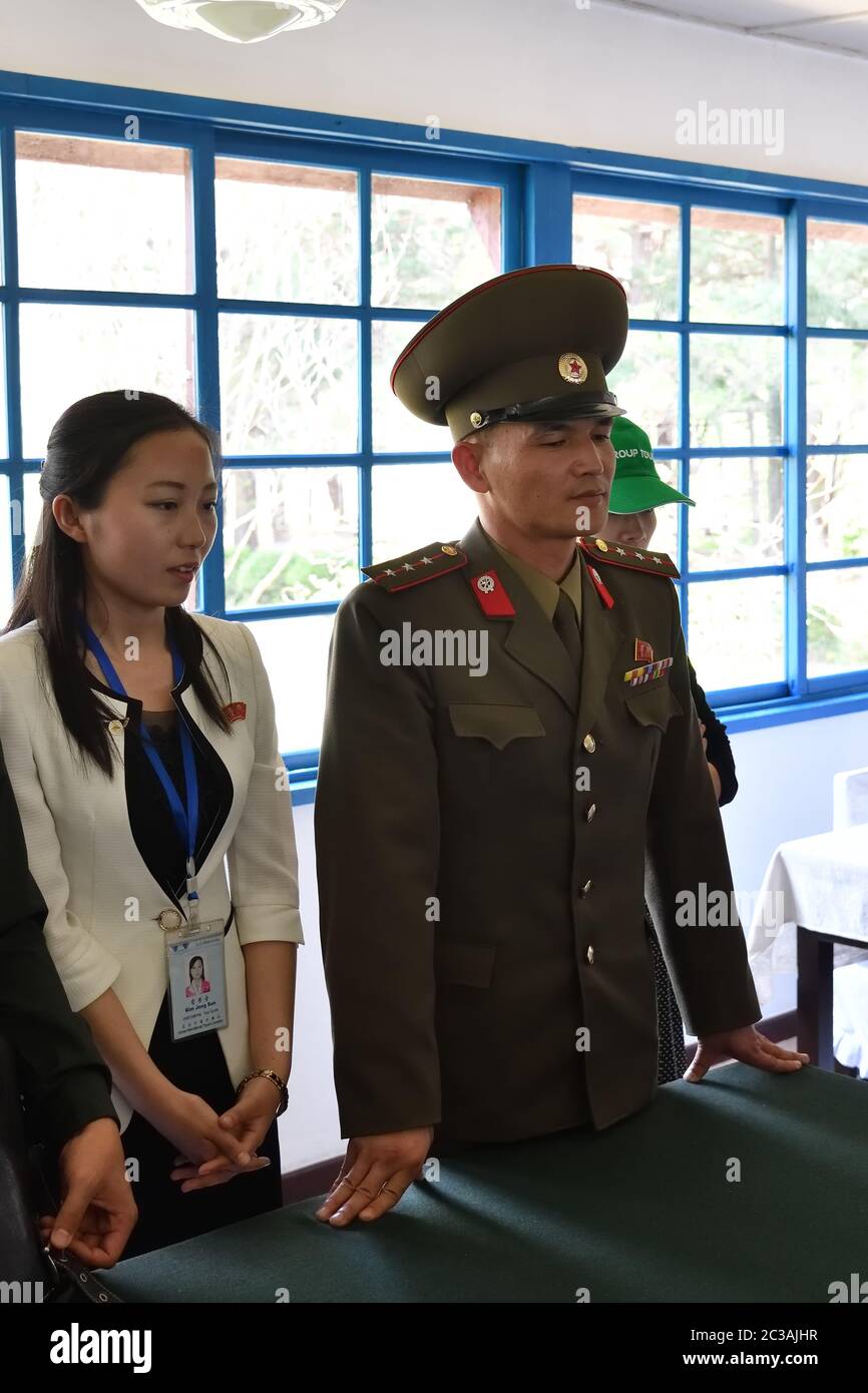 Panmunjom, North Korea - May 5, 2019:Guide in uniform gives tourists explanation abou the North Korea Peace Museum in Joint Security Area. The demilit Stock Photo