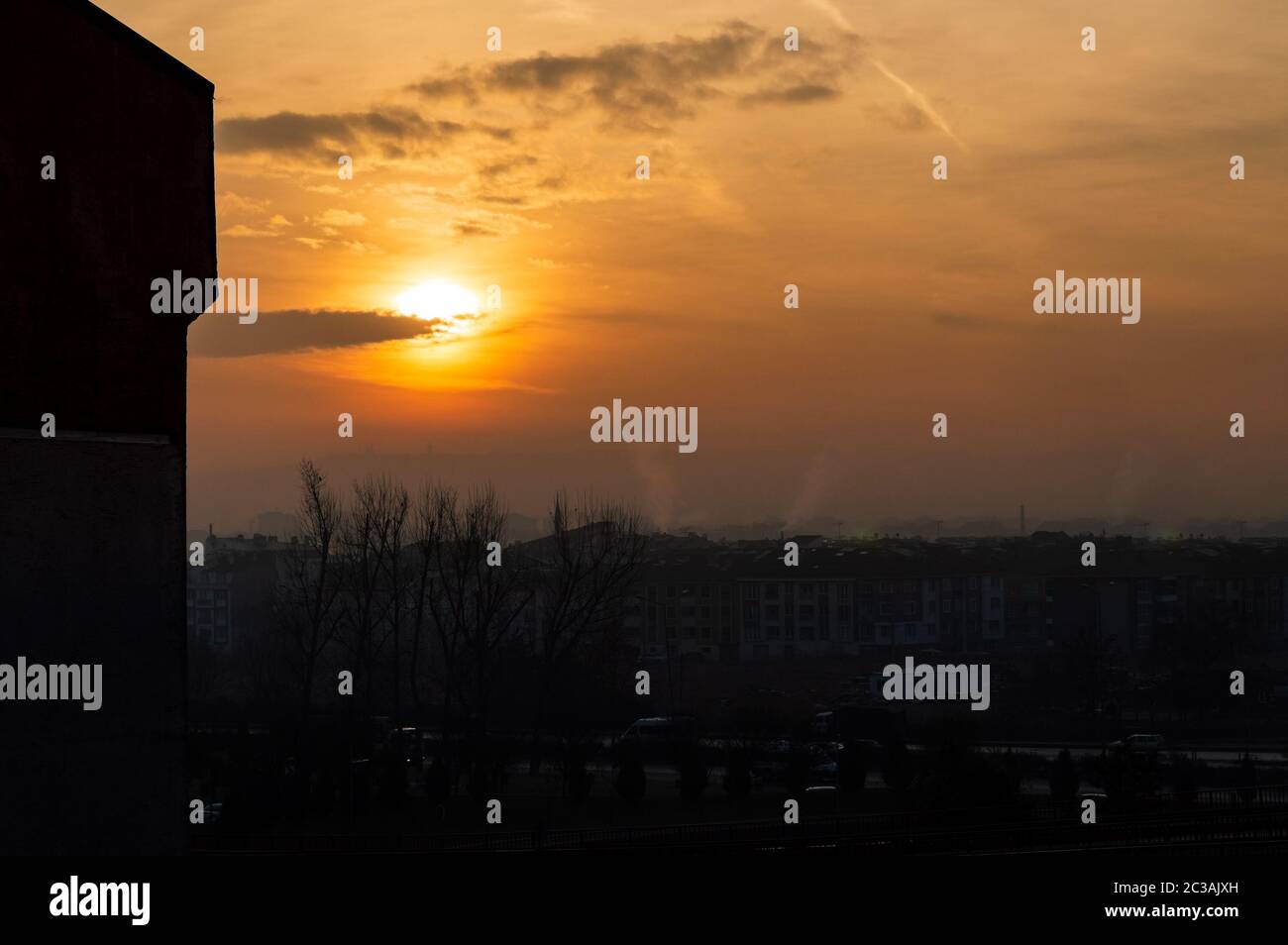 Beautiful sunset scenery over the city, orange sky and city silhouette background. Stock Photo