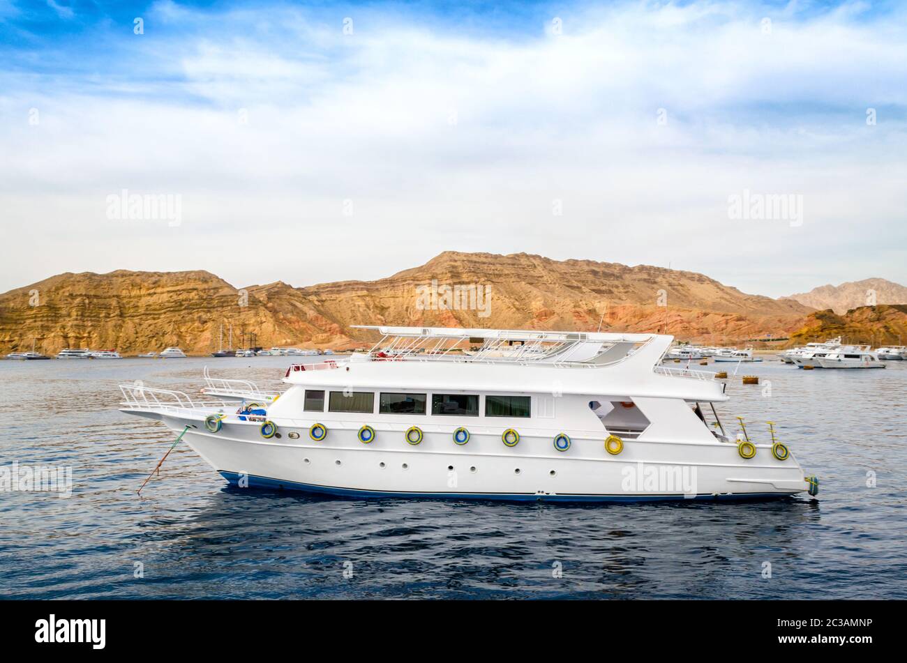 cruise tourist white boat in the Red Sea off the rocky coast in Egypt ...