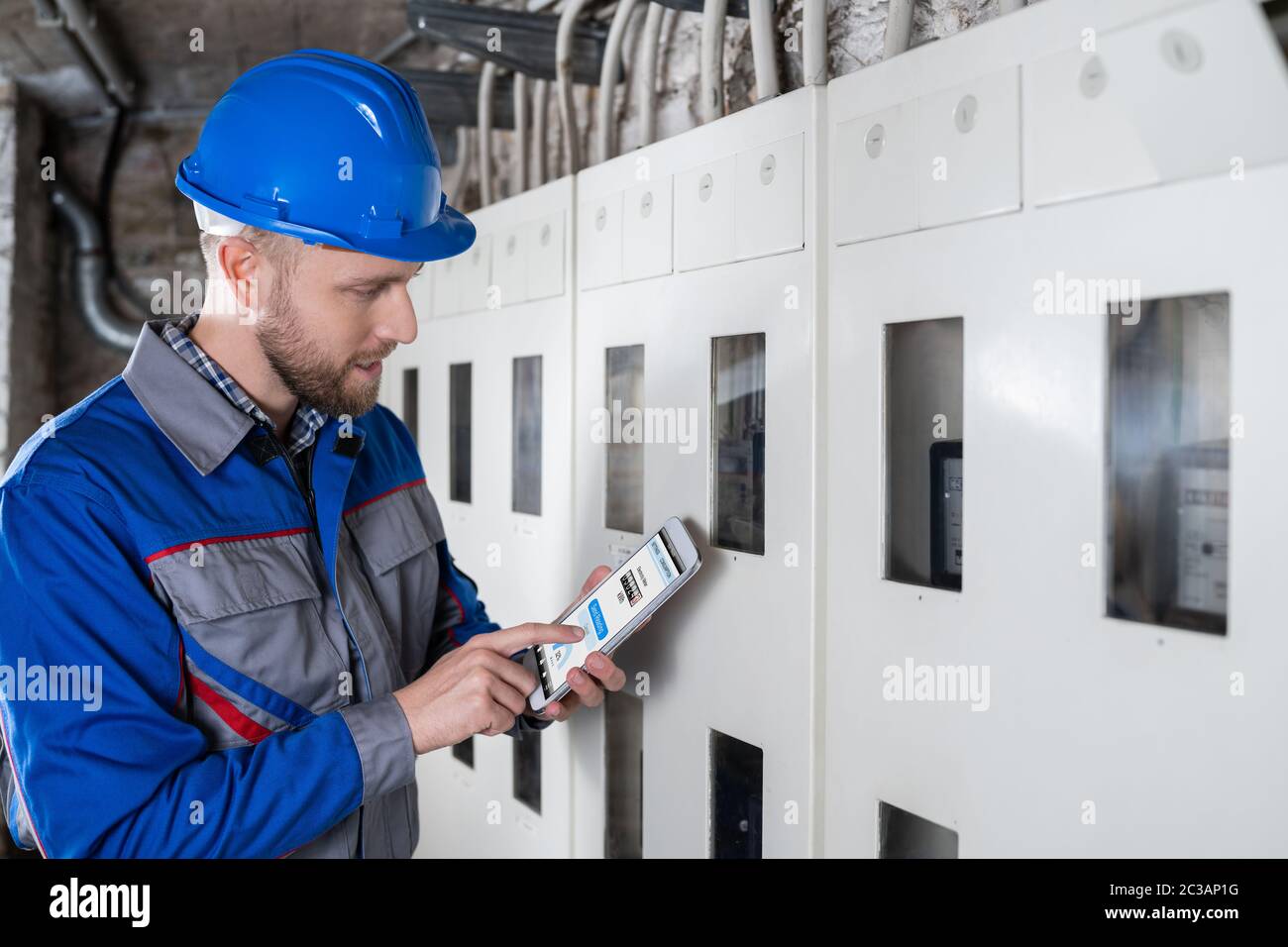 Male Technician Doing Meter Reading Using Tablet Stock Photo