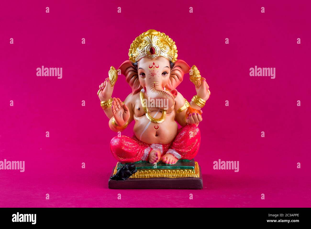 Hindu God Ganesha. Ganesha Idol on pink background Stock Photo - Alamy