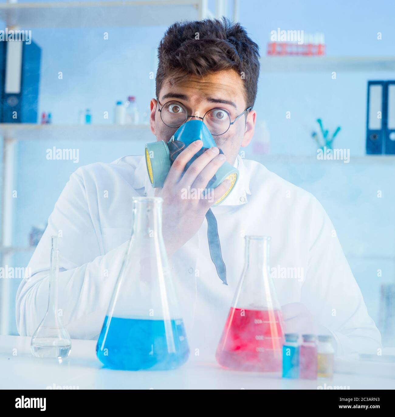 Funny mad chemist working in a laboratory Stock Photo