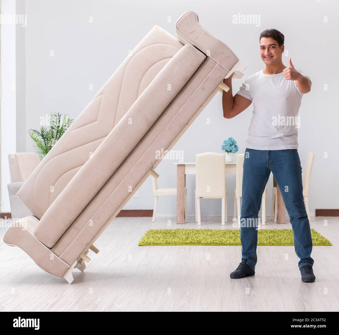 Man moving furniture at home Stock Photo Alamy