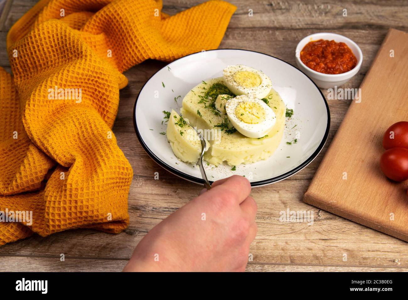 Potato food . Ingredients for mashed potatoes - eggs, milk, butter and potatoes on wooden background. Top view Stock Photo