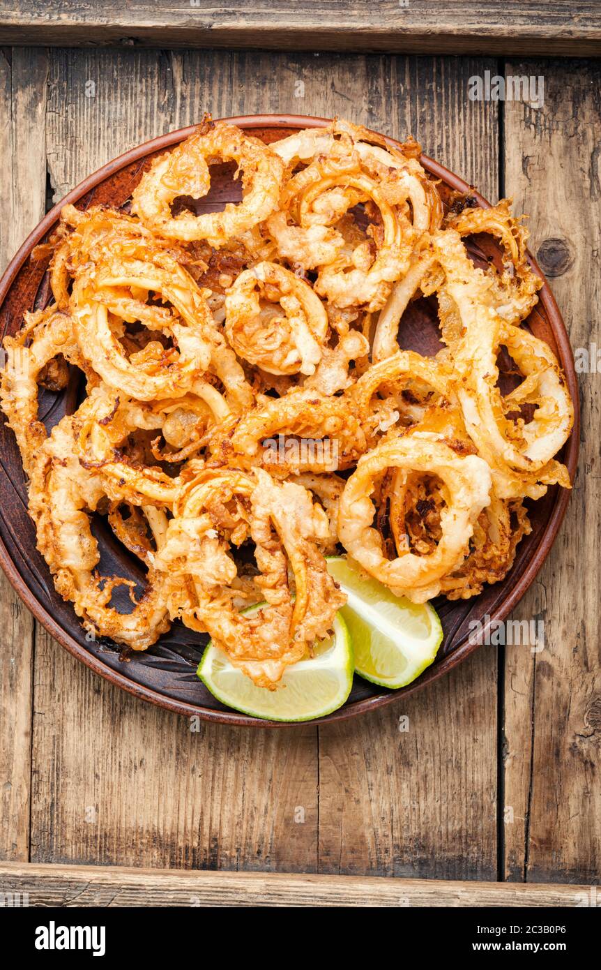 Crunchy deep fried squid rings in batter Stock Photo - Alamy