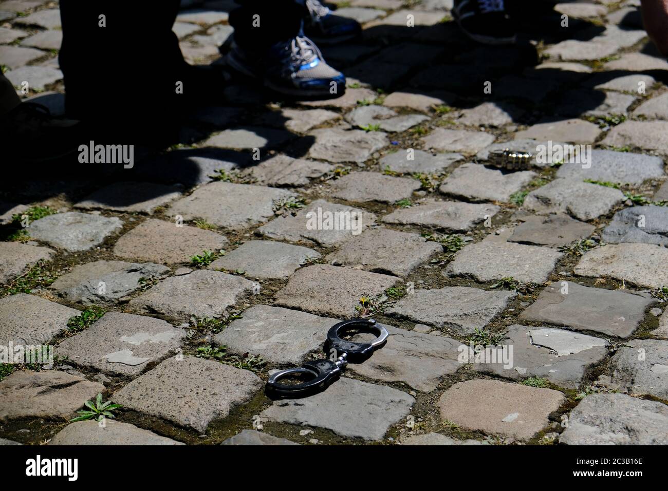Brussels, Belgium. 19th June, 2020. Handcuffs left on the ground by police officers are pictured during a protest violence against the police and a perceived anti-police sentiment in the media. Credit: ALEXANDROS MICHAILIDIS/Alamy Live News Stock Photo