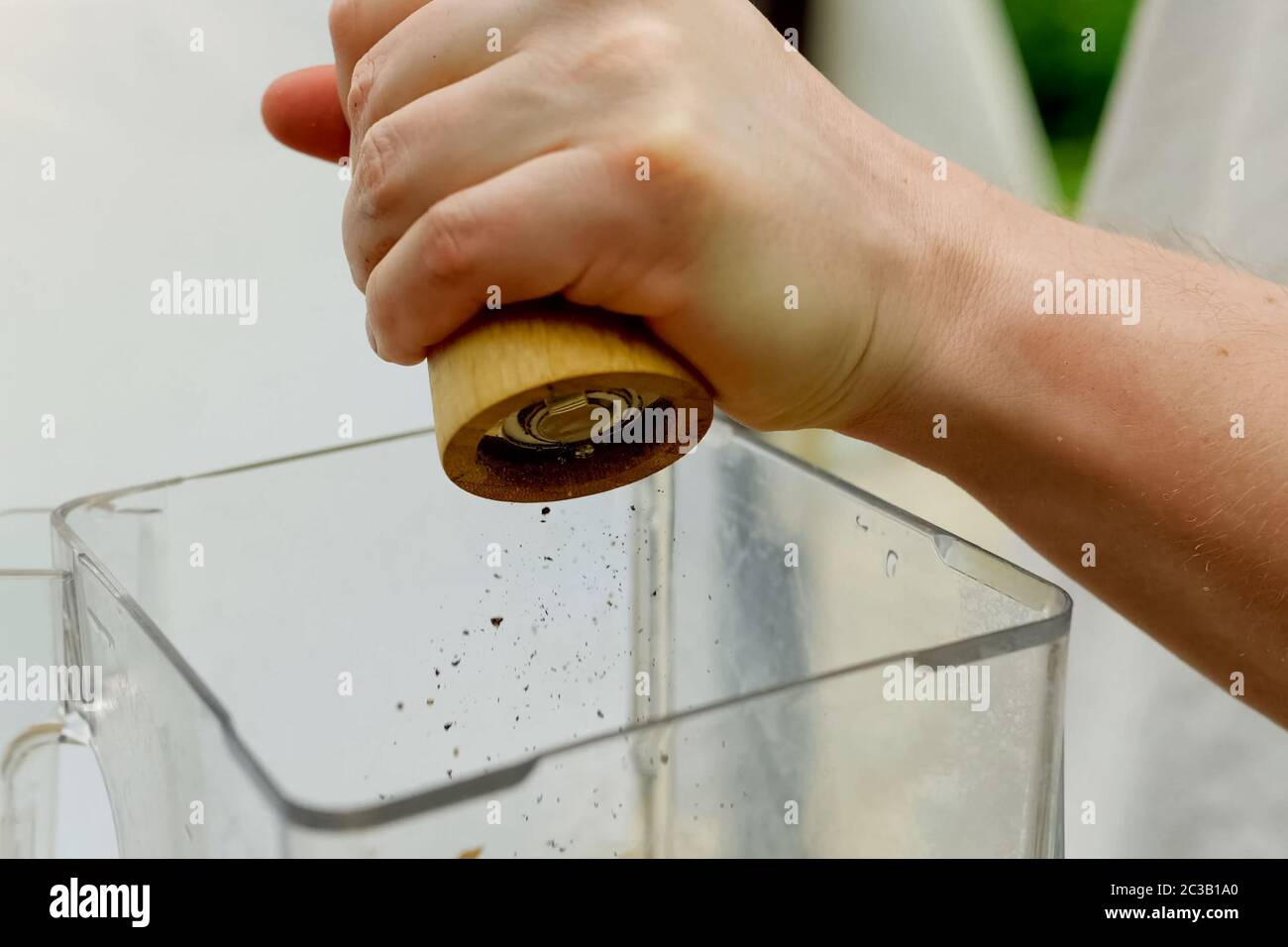 Grinding spices and shaking them in a dish. Spices in food Stock Photo