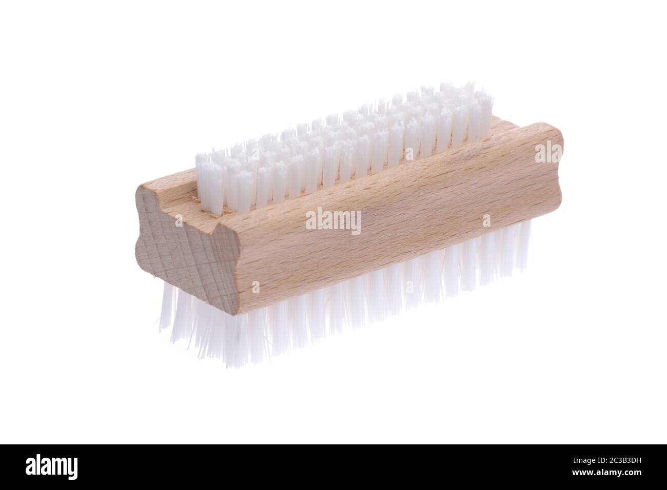 traditional wood nail brush with short bristles inclined on a white background Stock Photo