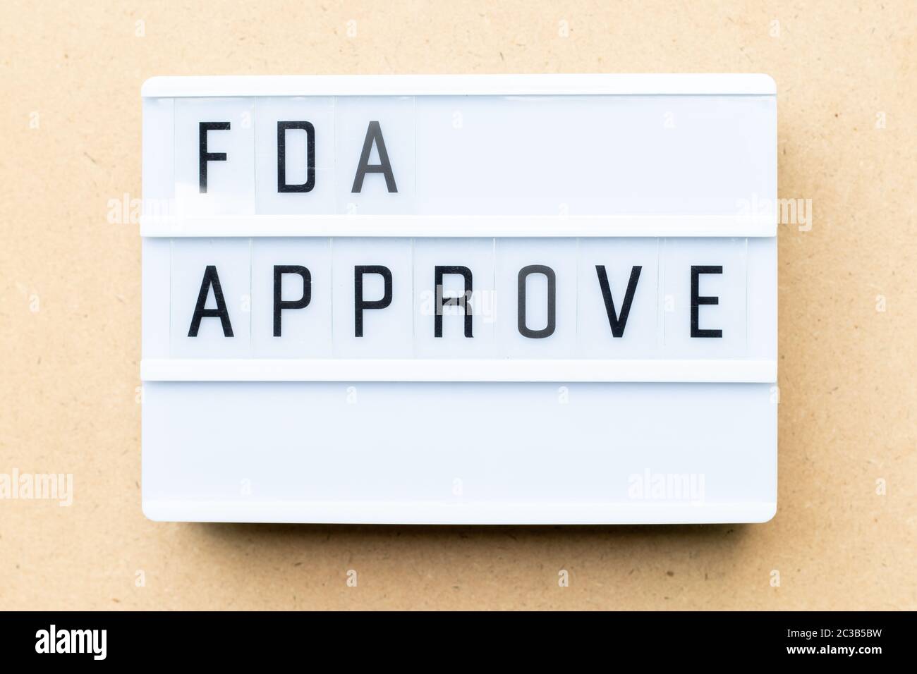 White lightbox with word fda approved on wood background Stock Photo