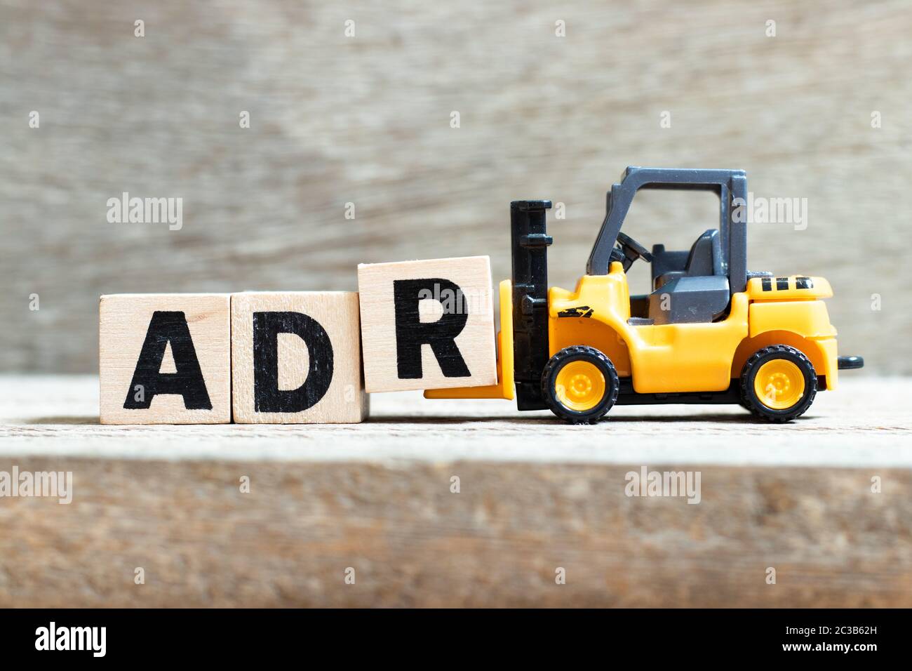 Toy Forklift Hold Letter Block R To Complete Word ADR Abbreviation Of Adverse Drug Reaction On 