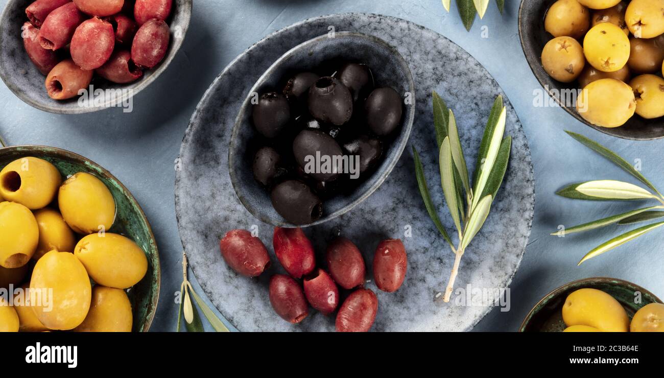 Olives flat lay panorama. Black, green and brown olives, shot from the top Stock Photo