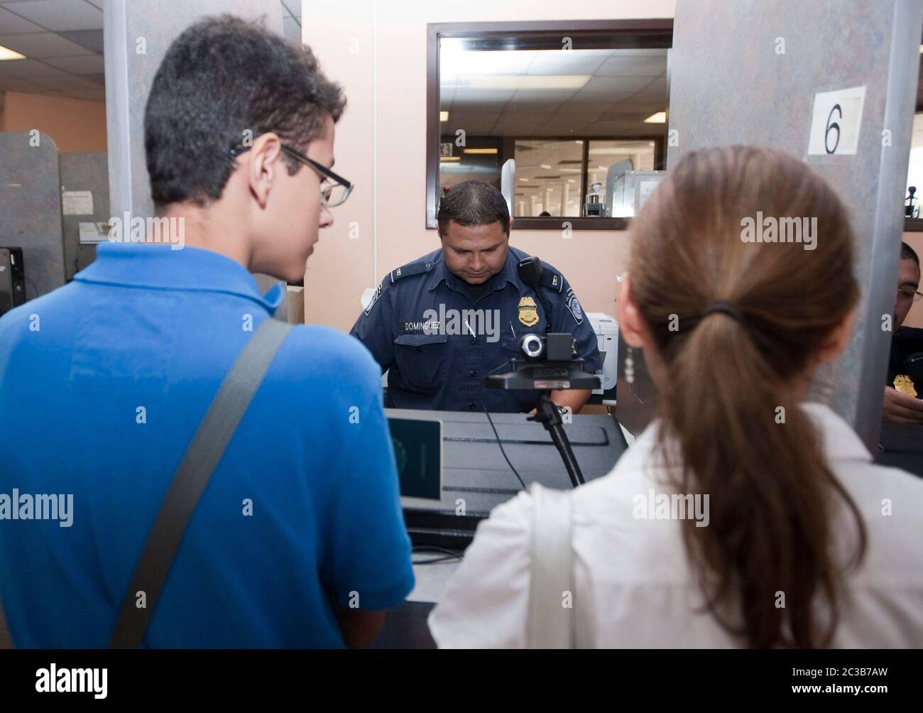 Laredo, Texas USA, 2012: At a U.S Customs and Border Protection checkpoint at the border between the United States and Mexico, an agent questions Mexican citizens before allowing them to travel into the U.S. ©MKC /  Daemmrich Photos Stock Photo