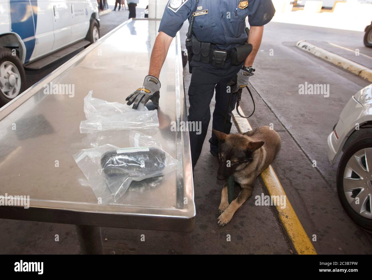 Laredo, Texas USA, 2012: At a U.S Customs and Border Protection station, an agent shows a bag full of drugs found by service dog during a training exercise. © MKC /  Daemmrich Photos Stock Photo