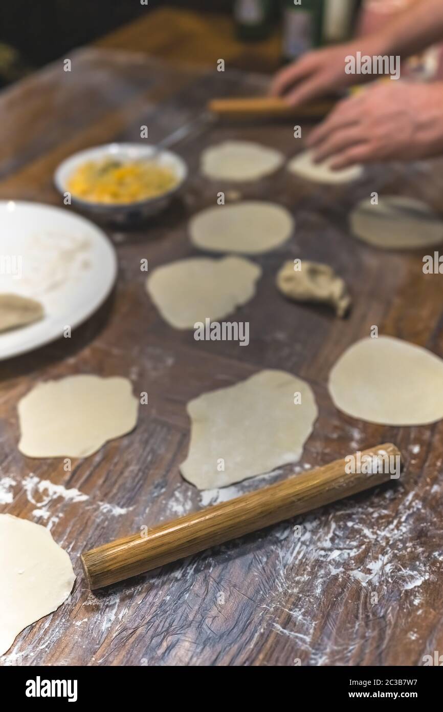 Wooden rolling pin which will be used for the making of traditional chinese dumplings during cooking class in a travellers hostel, Chengdu, Sichuan Pr Stock Photo