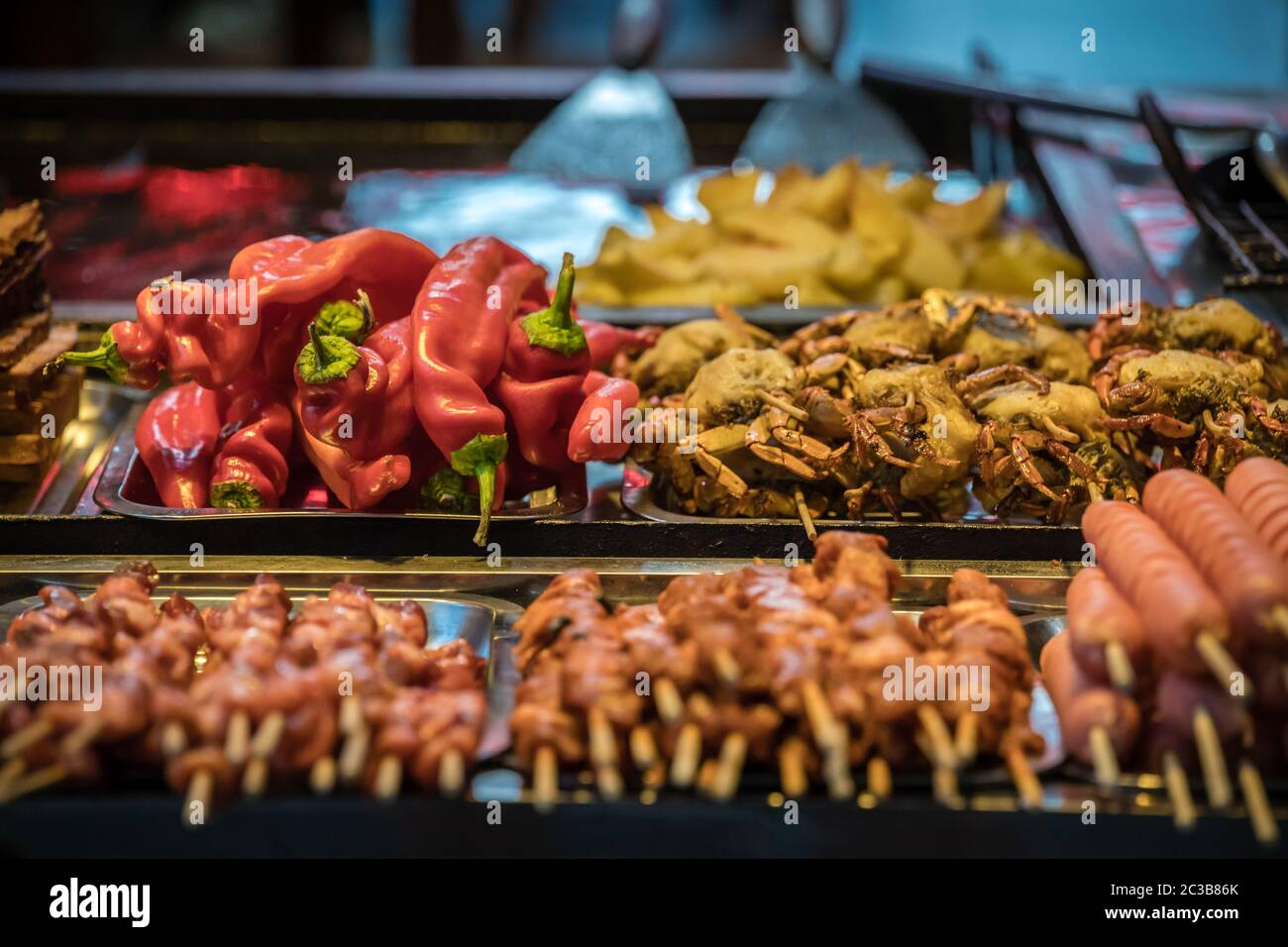 Hot buffet ingredients including peppers, crabs and sausage and meat sticks, ready to be grilled on the street in the Muslim Quarter, Xian town, China Stock Photo