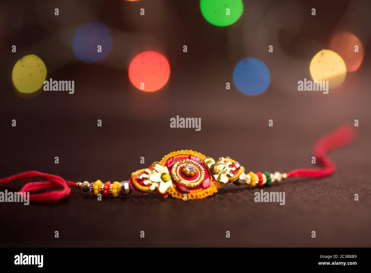Raksha Bandhan background with an elegant Rakhi. A traditional Indian ...