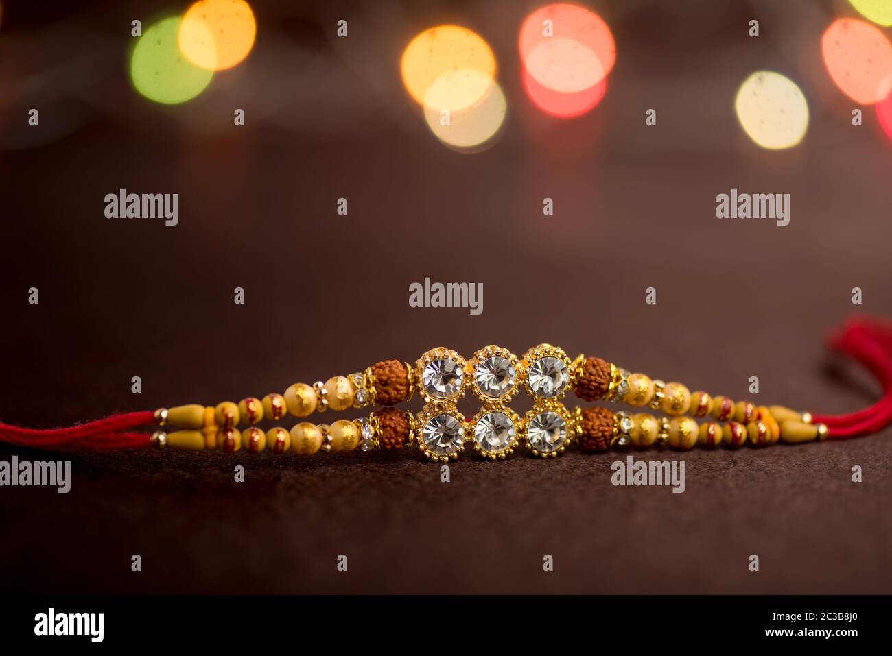 Raksha Bandhan background with an elegant Rakhi. A traditional Indian wrist band which is a symbol of love between Brothers and Sisters. Stock Photo