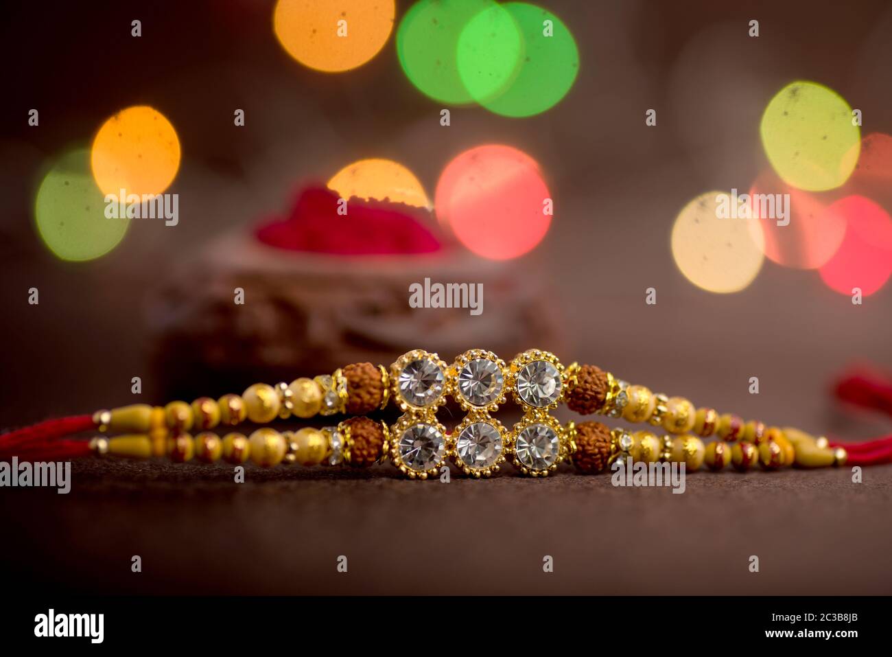 Raksha Bandhan background with an elegant Rakhi. A traditional Indian ...