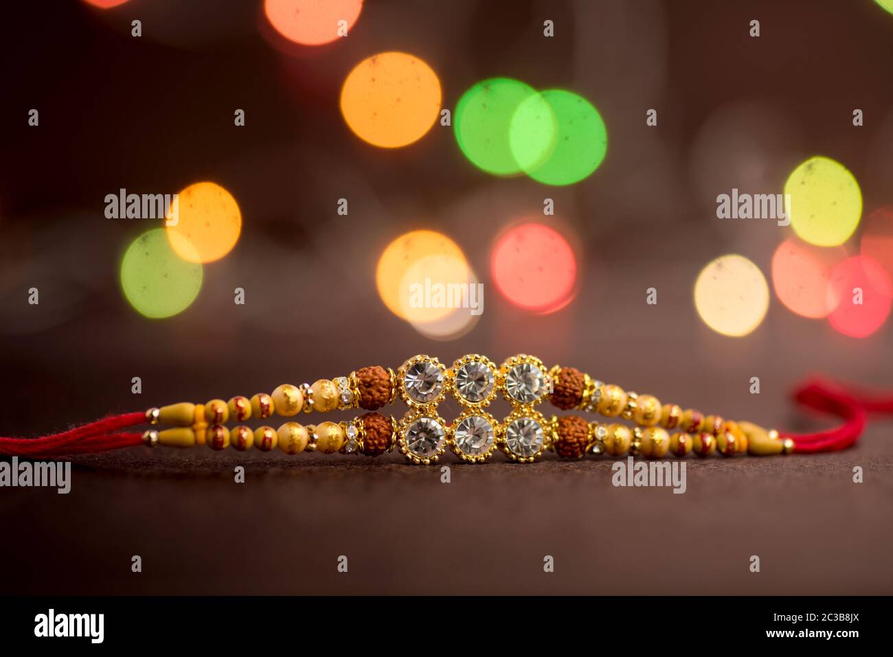 Raksha Bandhan background with an elegant Rakhi. A traditional Indian ...