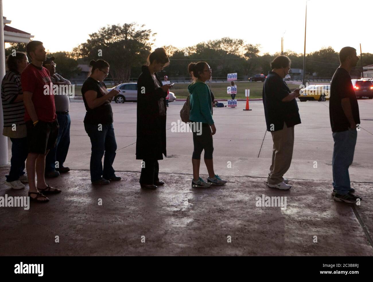 November 6th, 2012 Austin, Texas: Voters stand in line and review ballot waiting to cast their vote in Travis County Texas.   ©MKC / Daemmrich Photos Stock Photo