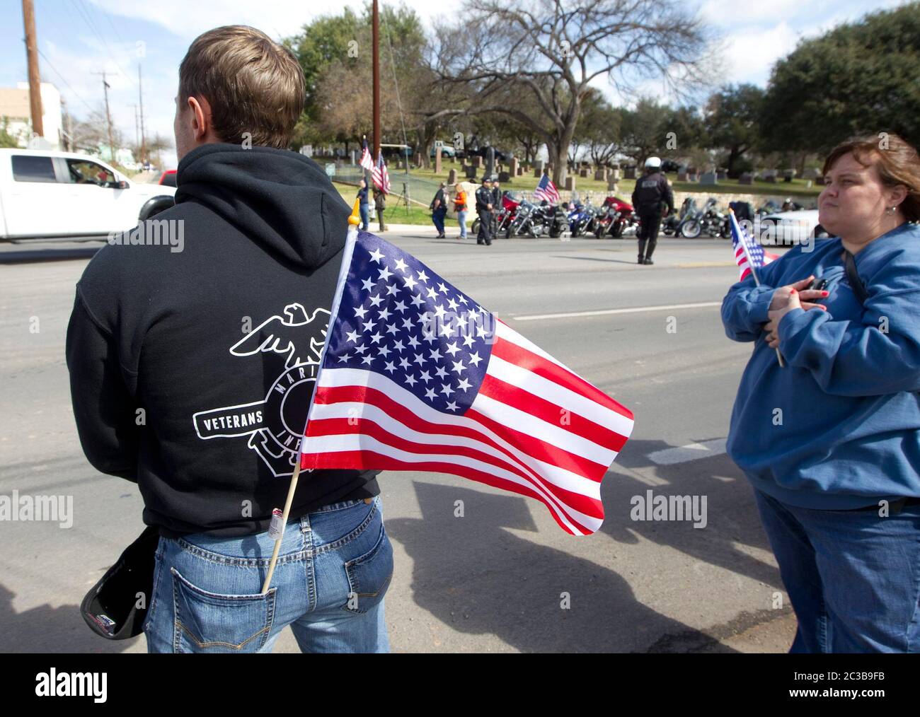 Austin Texas USA, February 12, 2013: Mourners line the street to pay respects to former Navy SEAL Chris Kyle as his funeral cortege passes on its way to his burial at the Texas State Cemetery. Kyle served four tours of duty as a sniper during the Iraq war, and wrote a book about his experiences there. He was fatally shot by a fellow Iraq war veteran at a gun range in Glen Rose, Texas on February 2. ©Marjorie Kamys Cotera/Daemmrich Photography Stock Photo
