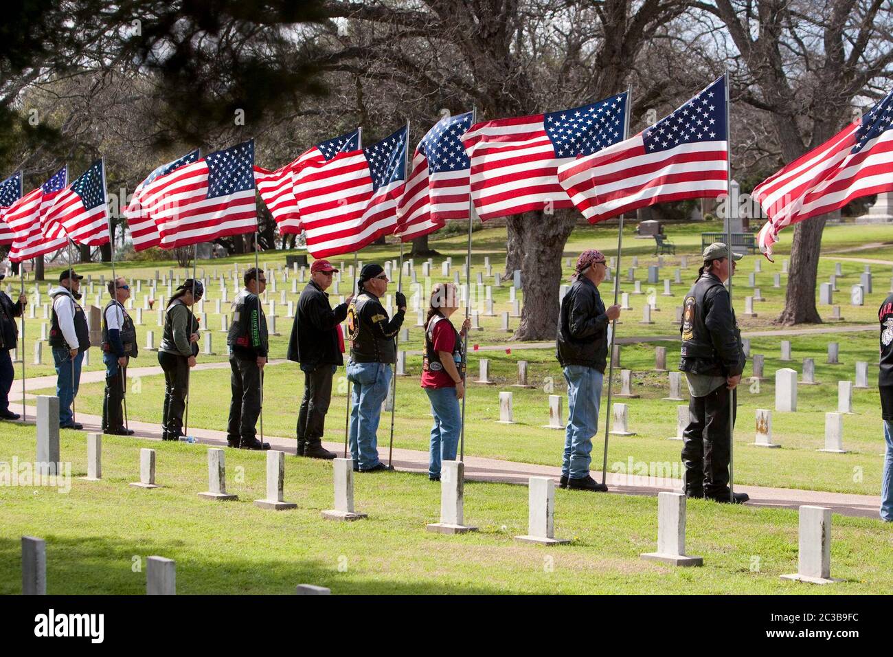 Austin Texas USA, February 12, 2013: Military veterans carrying American flags participate in the funeral service for former Navy SEAL Chris Kyle at the Texas State Cemetery. Kyle served four tours of duty as a sniper during the Iraq war, then wrote a popular book about his experiences there. He was fatally shot by a fellow Iraq war veteran at a gun range in Glen Rose, Texas on February 2. ©Marjorie Kamys Cotera/Daemmrich Photography Stock Photo