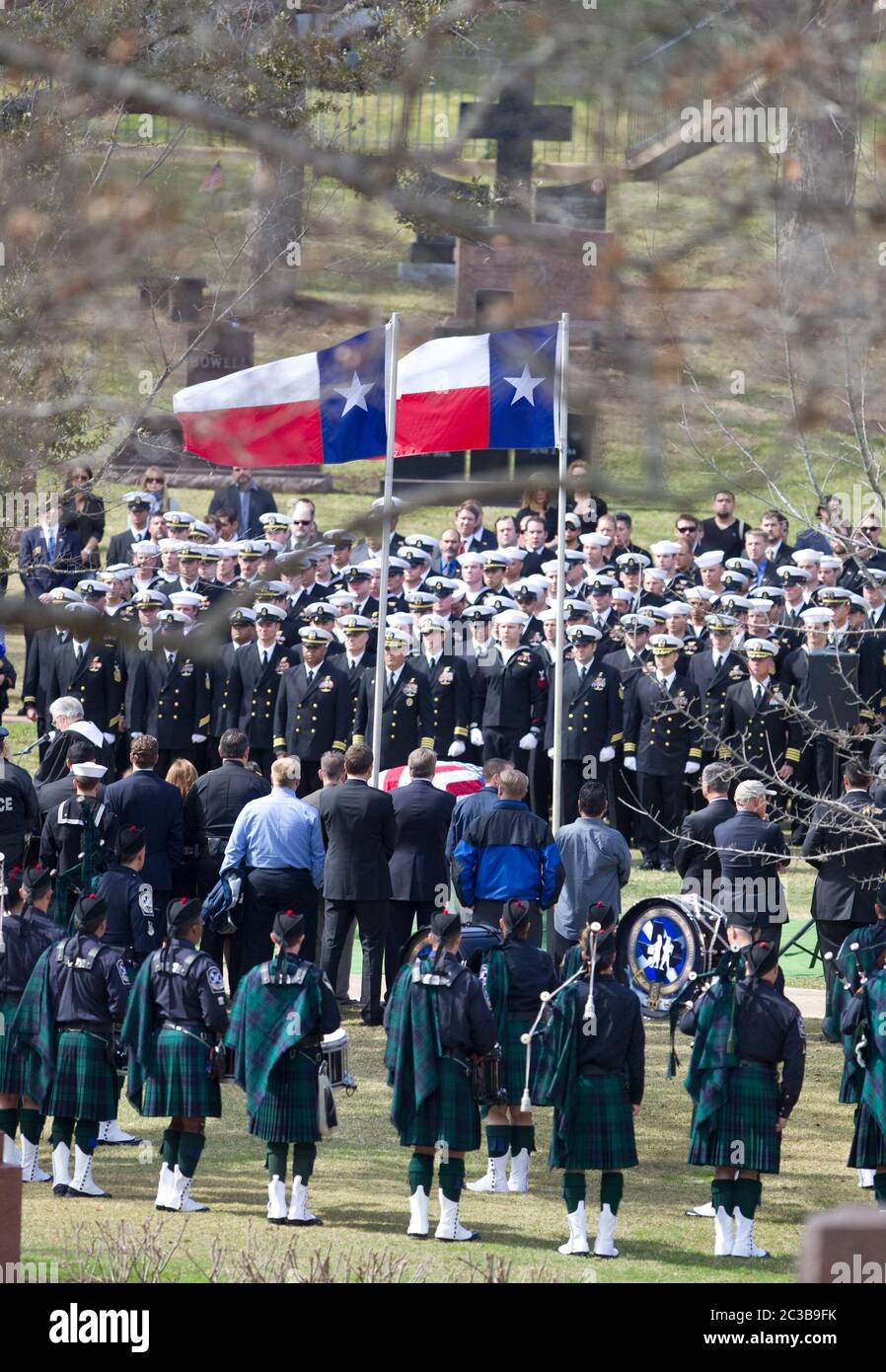 Austin Texas USA, February 12, 2013: Two Texas state flags fly over the flag-draped coffin of former Navy SEAL Chris Kyle during Kyle's funeral at the Texas State Cemetery. Kyle served four tours of duty as a sniper during the Iraq war, then wrote a popular book about his experiences there. He was fatally shot by a fellow Iraq war veteran at a gun range in Glen Rose, Texas on February 2. ©Marjorie Kamys Cotera/Daemmrich Photography Stock Photo
