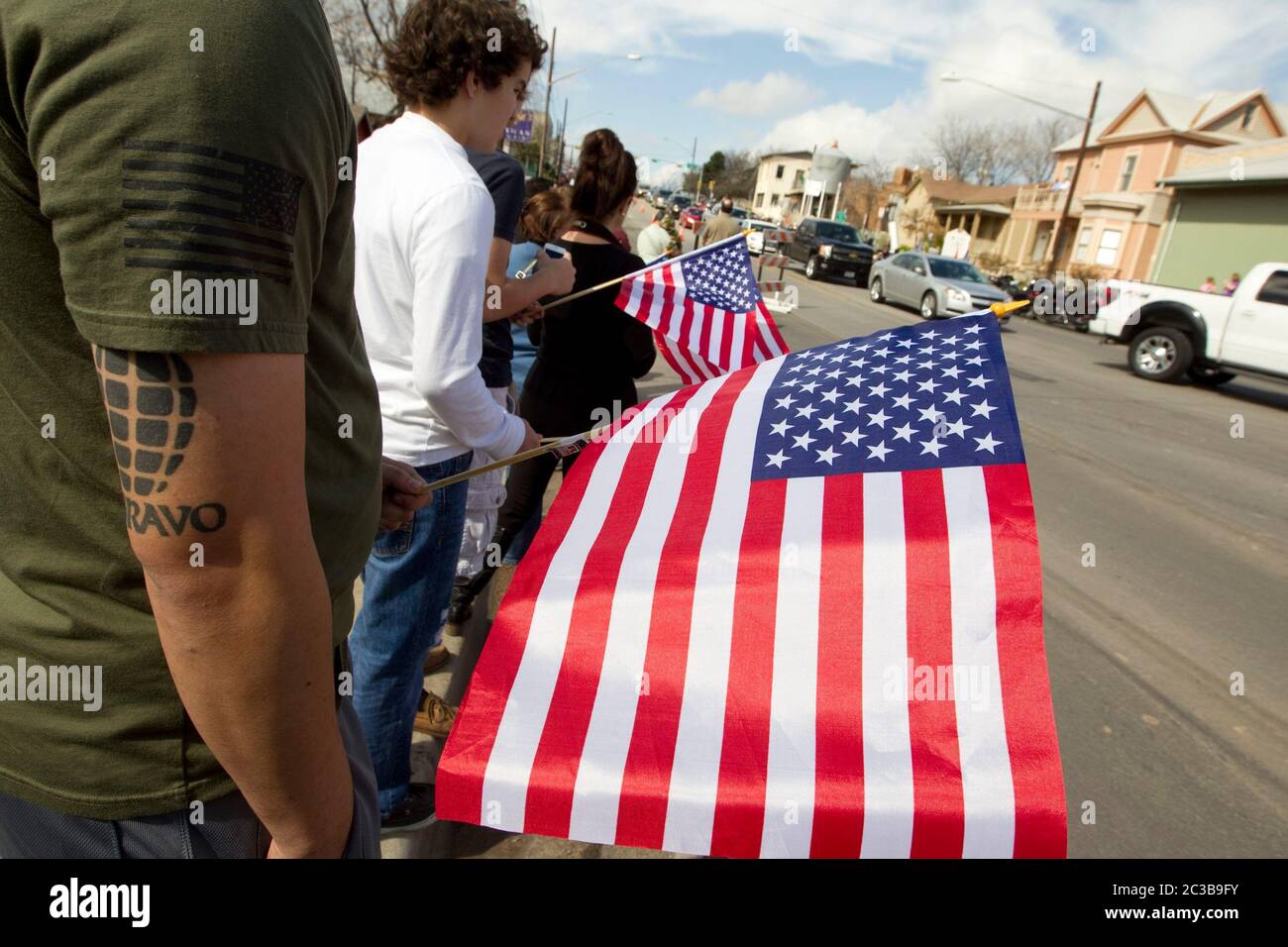 Austin Texas USA, February 12, 2013: Mourners line the street to pay respects to former Navy SEAL Chris Kyle as his funeral cortege passes on its way to his burial at the Texas State Cemetery. Kyle served four tours of duty as a sniper during the Iraq war, and wrote a popular book about his experiences there. He was fatally shot by a fellow Iraq war veteran at a gun range in Glen Rose, Texas on February 2. ©Marjorie Kamys Cotera/Daemmrich Photography Stock Photo