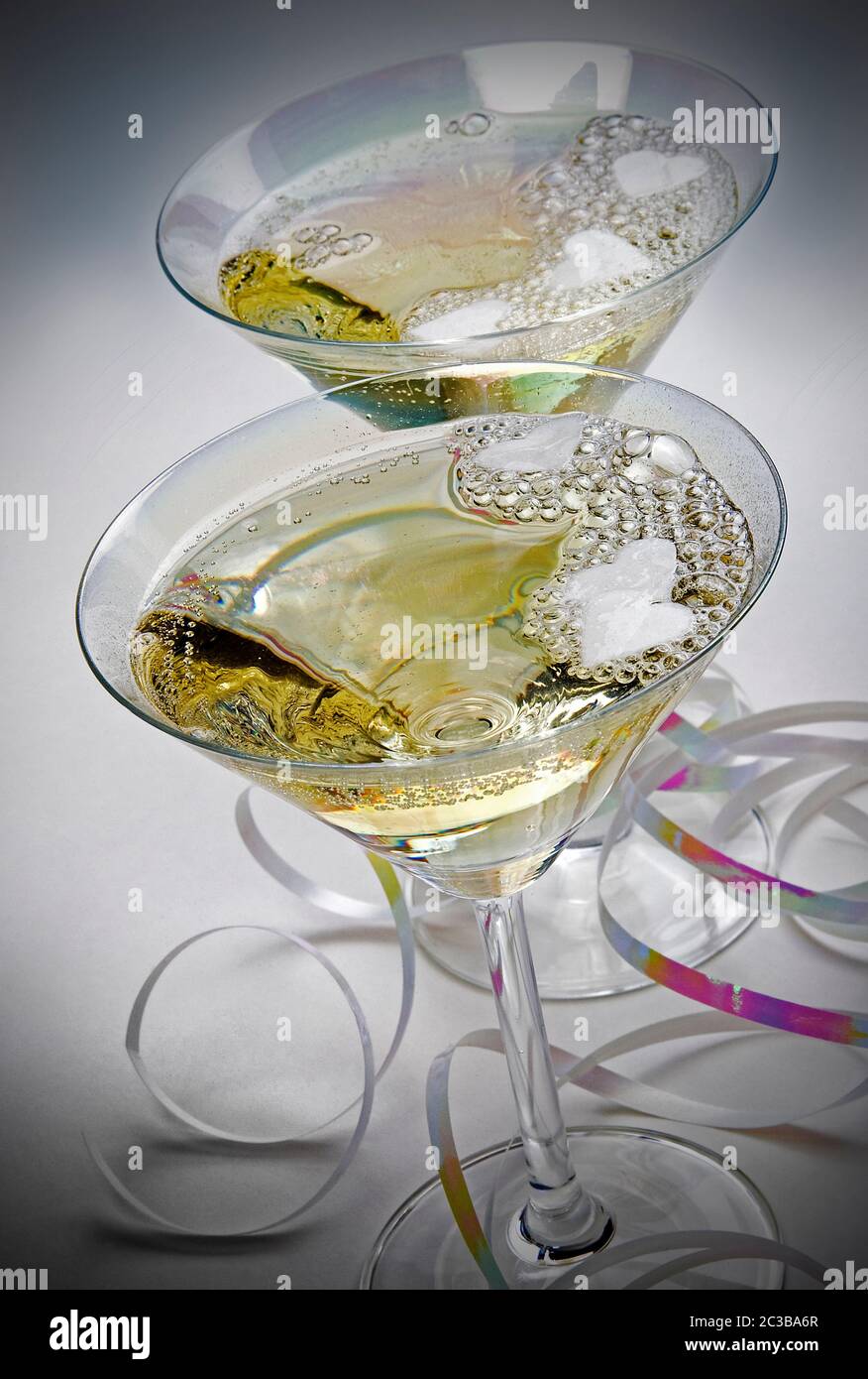 Champagne in glasses with ribbon on plain background and elevated viewpoint Stock Photo