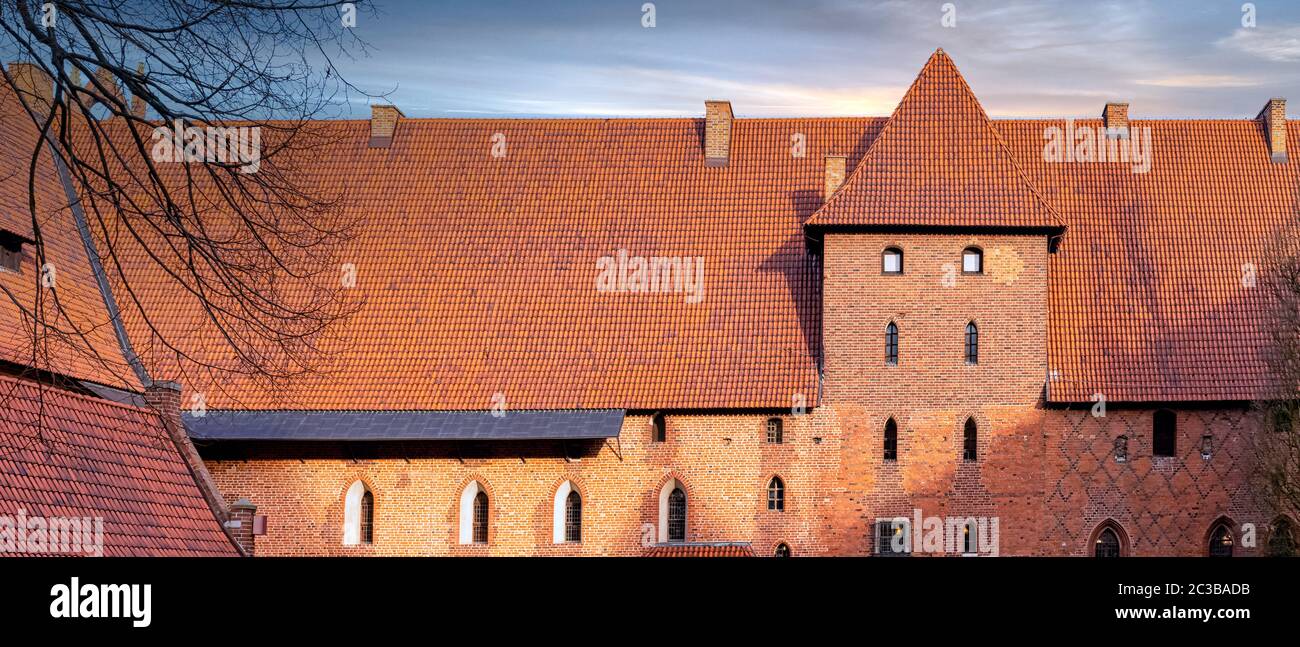 Sunrise over Castle of the Teutonic Order in Malbork - the largest castle in the world by land area in Malbork, Pomerania, Poland Stock Photo