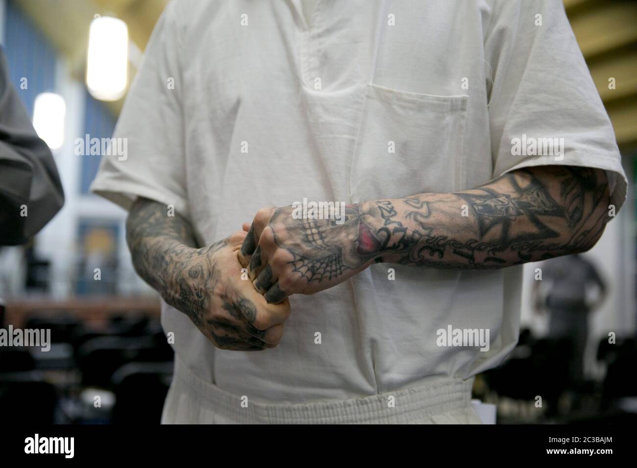 Rosharon Texas USA, August 25 2014: Heavily tattooed uniformed male inmate at the high-security Darrington prison stands in the lockup's chapel. He is attending a session that is part of a course for the Southwestern Baptist Theological Seminary, in which a number of prisoners are enrolled.  ©Marjorie Kamys Cotera/Daemmrich Photography Stock Photo