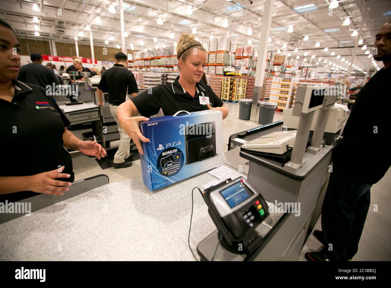 Cedar Park Texas USA, November 11 2013: Costco warehouse club employee checks out customer at newly opened store in a fast-growing Austin suburb. ©Marjorie Kamys Cotera/Daemmrich Photography Stock Photo