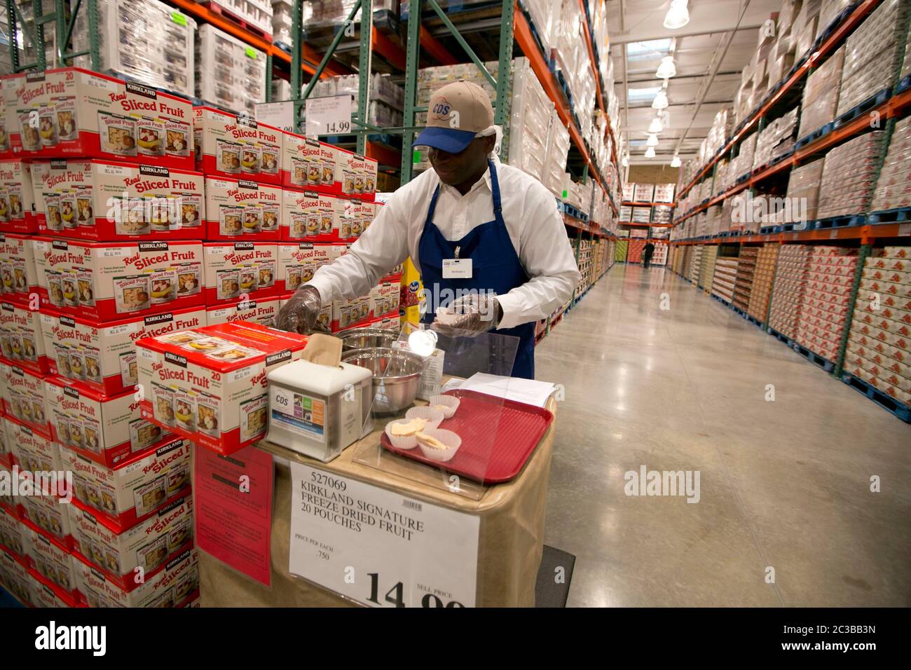 Cedar Park Texas USA, November 22 2013: Employee sets up free samples of fruit topping at newly opened Costco warehouse club in a fast-growing Austin suburb.   ©Marjorie Kamys Cotera/Daemmrich Photography Stock Photo