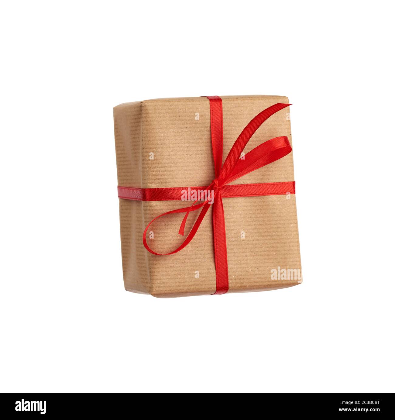 rectangular box wrapped in brown paper and tied with a red bow, gift ...