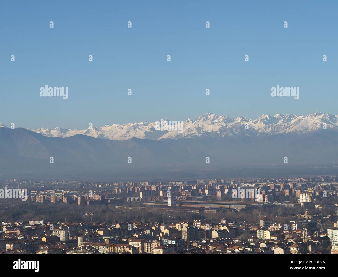 Aerial view of the city of Turin, Italy with Alps mountain range in the ...