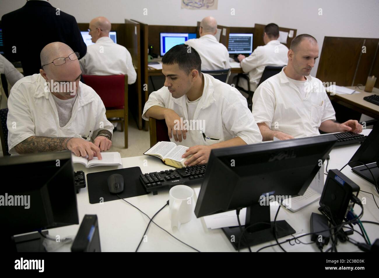 Rosharon Texas USA, August 25 2014: Male prison inmates, students who are enrolled in the Southwestern Baptist Theological Seminary program at Darrington prison, use computers in their classroom, where they are allowed to interact with each other.   ©Marjorie Kamys Cotera/Daemmrich Photography Stock Photo