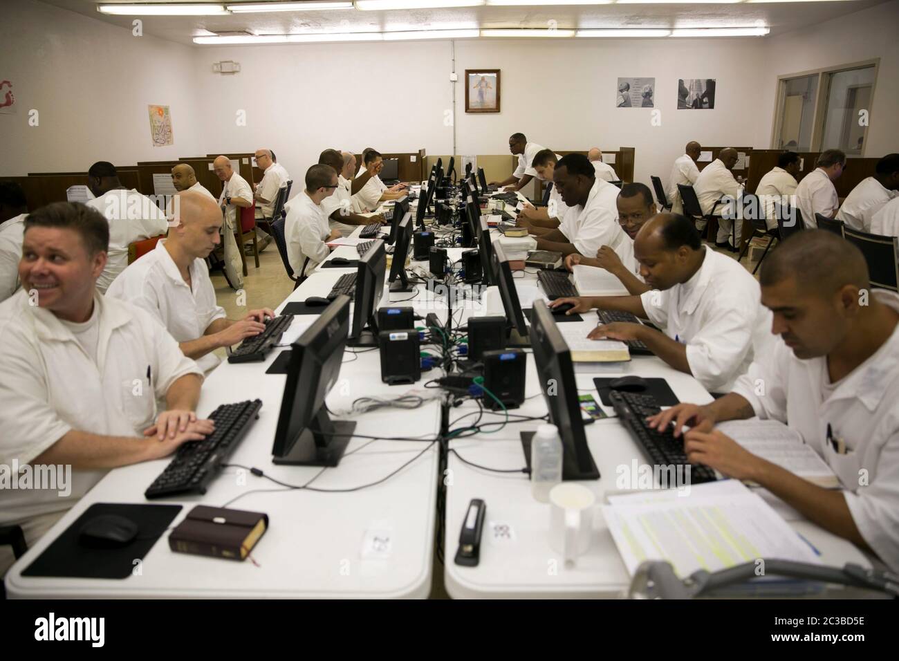 Rosharon Texas USA, August 25 2014: Male prison inmates, students who are enrolled in the Southwestern Baptist Theological Seminary program at Darrington prison, use computers in their classroom, where they are allowed to interact with each other.   ©Marjorie Kamys Cotera/Daemmrich Photography Stock Photo