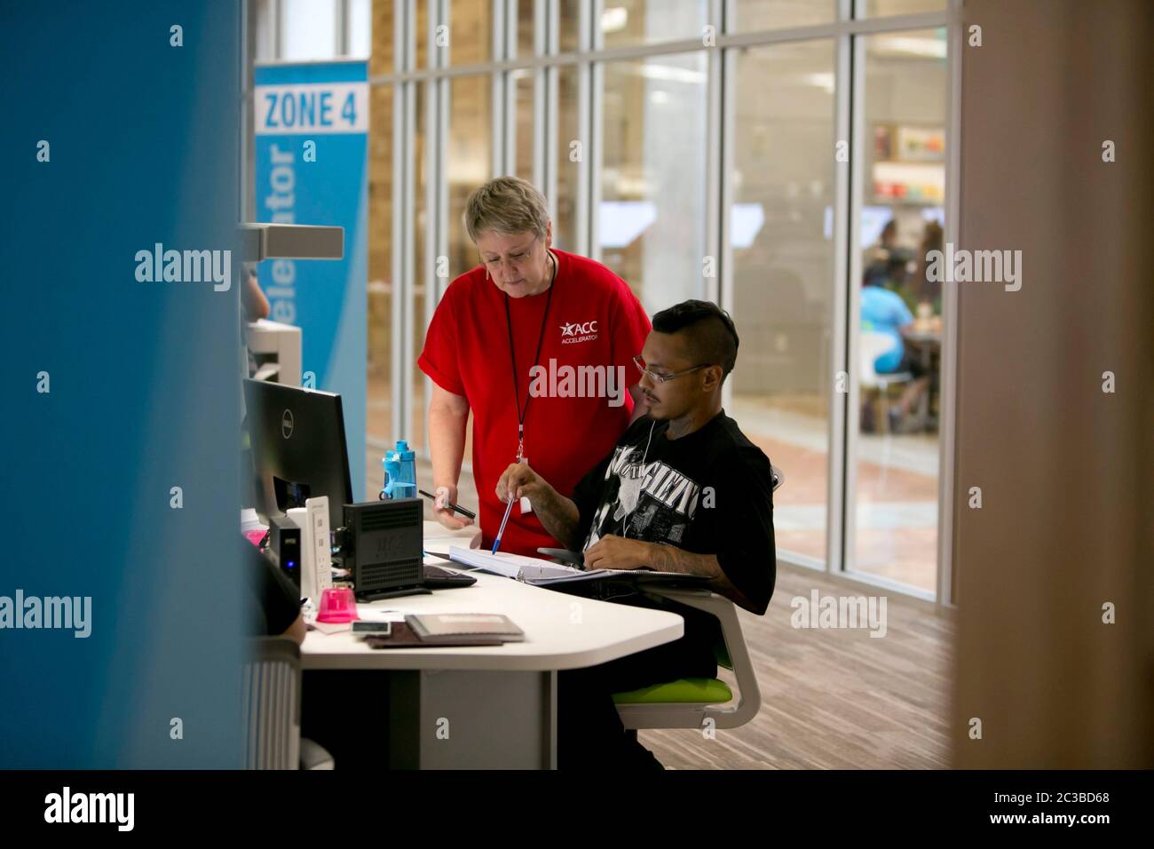 Austin, Texas USA, August 27, 2014: Tutor talks to student inside the ...