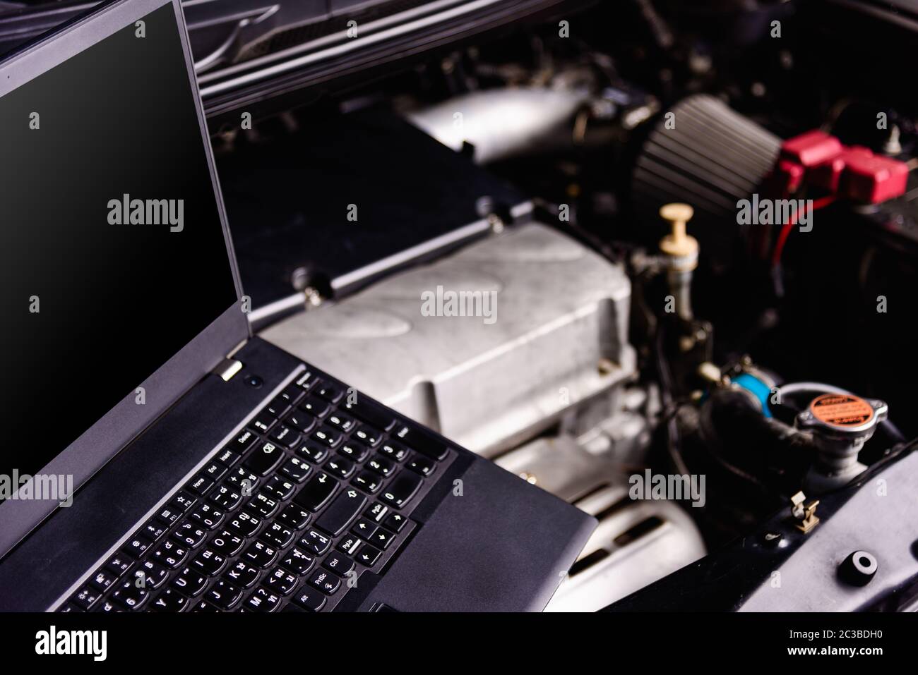 Laptop computer on car mechanic engine for service at Stock Photo Alamy