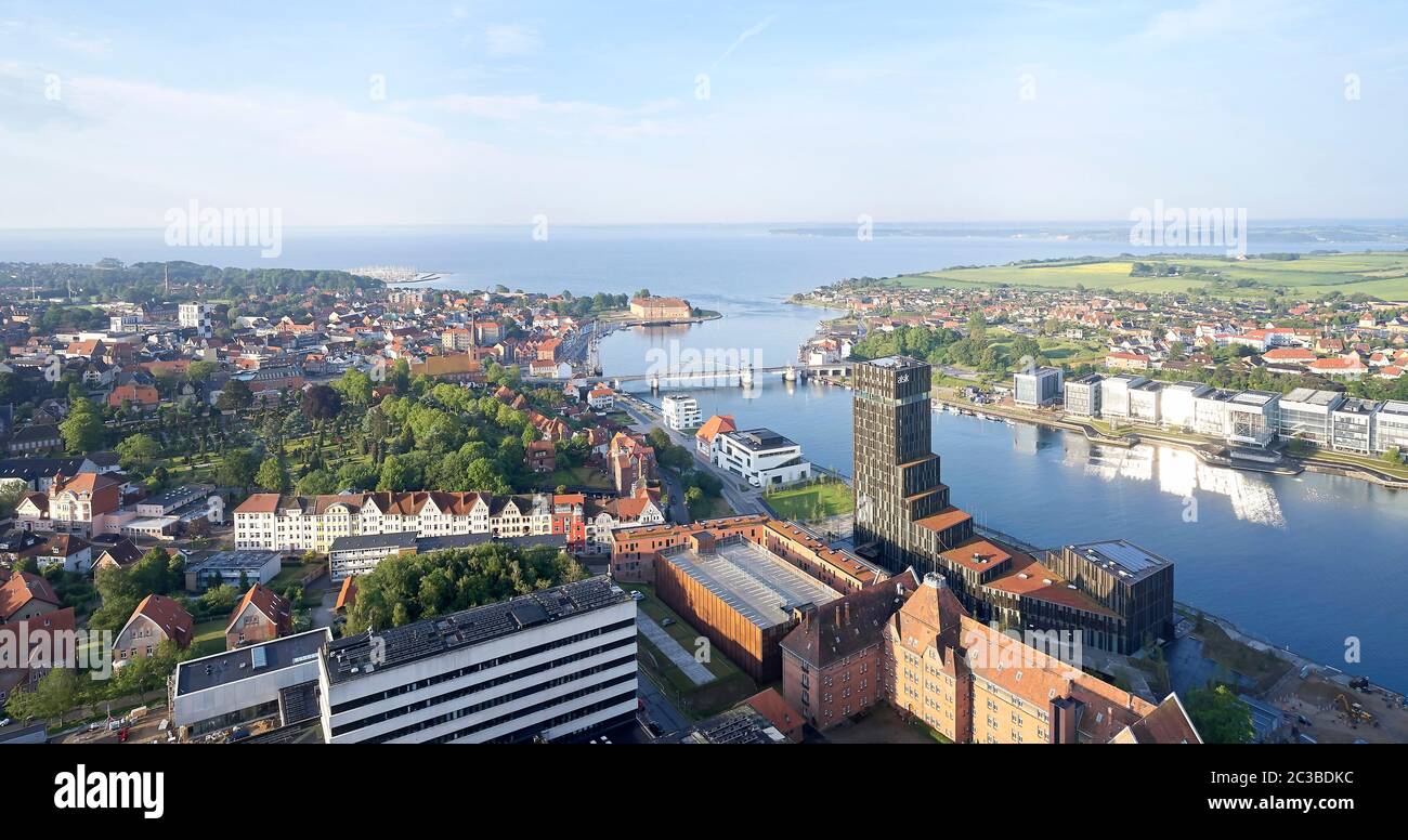 Aerial view from north with river and cityscape. Hotel Alsik, Sønderborg, Denmark. Architect: Henning Larsen, 2019. Stock Photo
