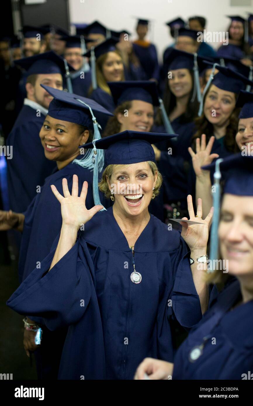 Houston , Texas USA, November 8, 2014: Students wearing traditional graduation regalia participate in Western Governors University commencement ceremony. WGU, a national online university that  offers competency-based degree programs, serves more than 50,000 students in 50 states. ©Marjorie Kamys Cotera/Daemmrich Photography Stock Photo