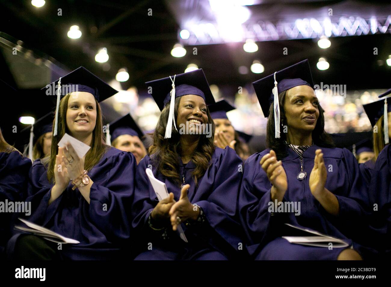 Houston , Texas USA, November 8, 2014: Students wearing traditional graduation regalia participate in Western Governors University commencement ceremony. WGU, a national online university that  offers competency-based degree programs, serves more than 50,000 students in 50 states. ©Marjorie Kamys Cotera/Daemmrich Photography Stock Photo