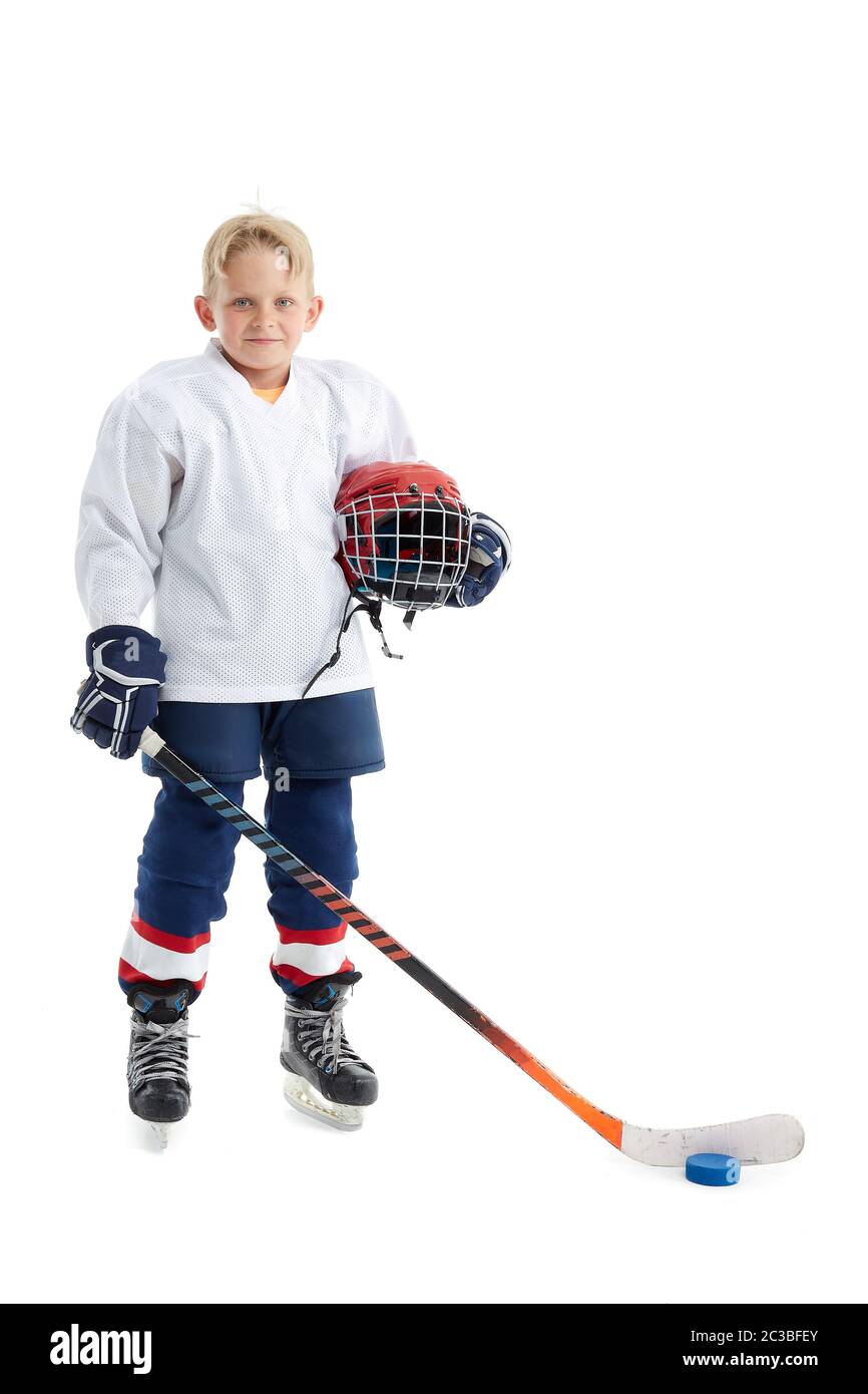 Isolated cute little kid hockey player in full hockey equipment